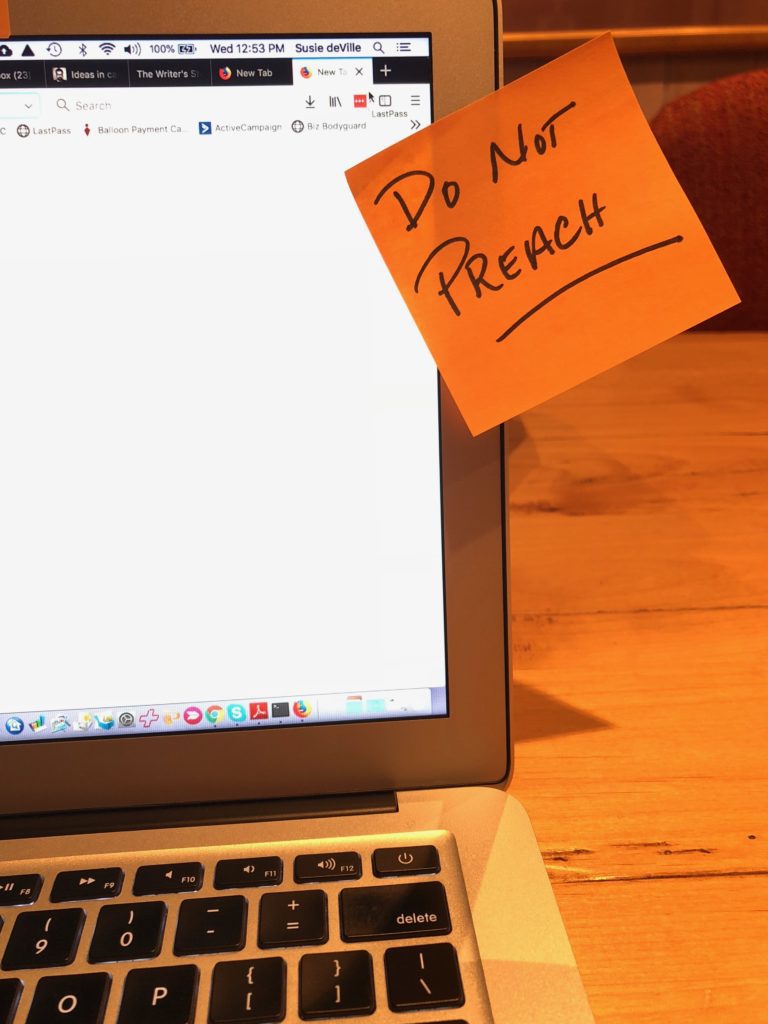 A sticky note that reads "Do Not Preach" sticks to the side of a laptop screen.