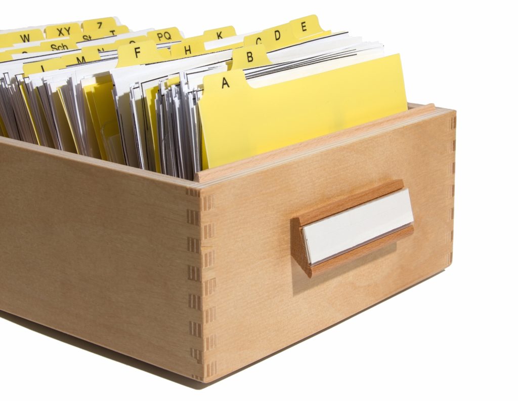 Wooden drawer filled with full alphabetized folders.
