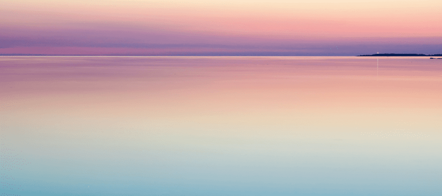 Pastel sunset over the water symbolizing how to calm anxiety