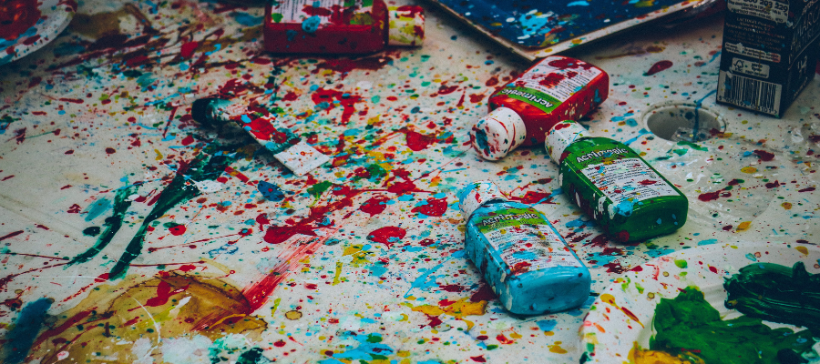 paint splattered table to symbolize the action: Embrace the mess