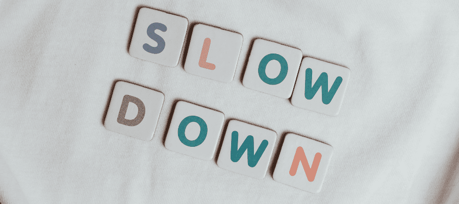 Letter blocks reading "Slow Down" in pastel color, explaining how to work on your dream project