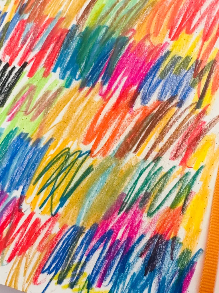 Multicolor crayon strokes layered on top of one another, an example of intuitive art