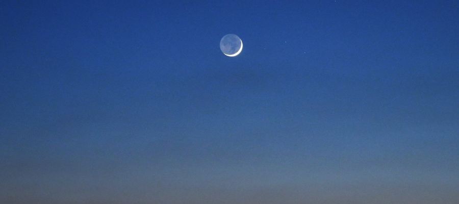 Photo of a new moon at dusk to represent new beginnings