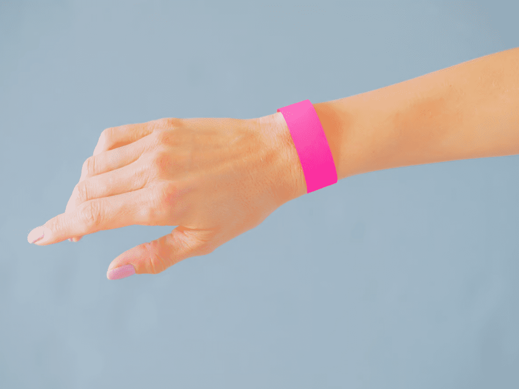 Photo of a person's hand wearing a pink wristband to represent Susie's complaint tracking experiment and her realizations about self-empowerment