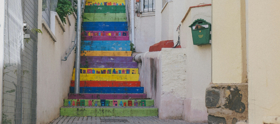 Colorful painted stairs in a residential neighborhood, representing how to follow your intuition and intellect down a path