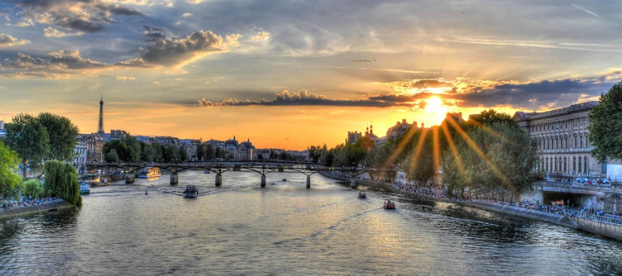 the sun over the Seine river in Paris to symbolize true connection and inspiration