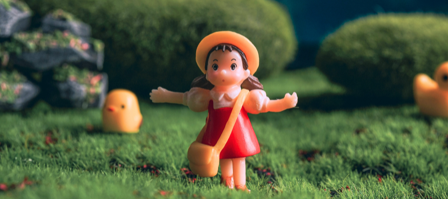 A small figuring of Mei Kusakabe from My Neighbor Totoro, a film by Hayao Miyazaki, standinng alone to represent Miyazaki's creation through despair.