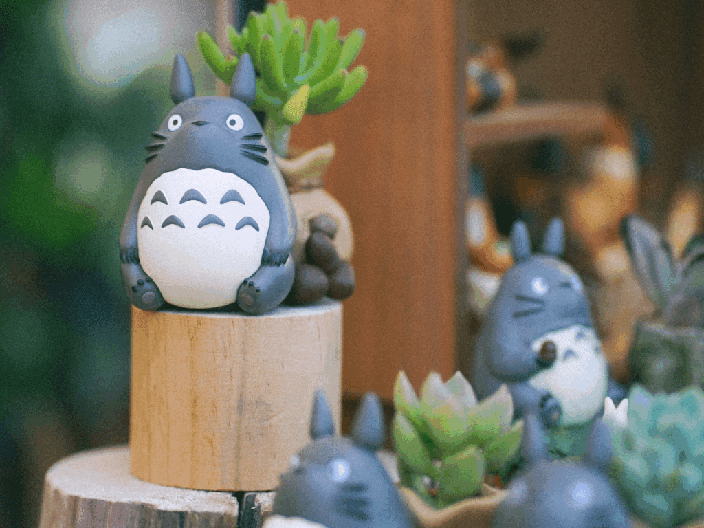A small figurine of Totoro from My Neighbor Totoro, a film by Hayao Miyazaki, standinng alone to represent Miyazaki's creation through despair.