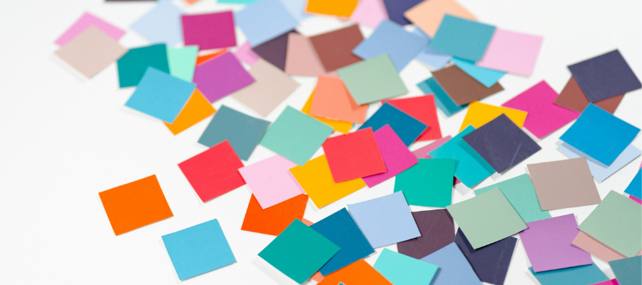 how to prioritize tasks; a flurry of colorful post-its on a white background go from blurry to focused to represent prioritizing tasks