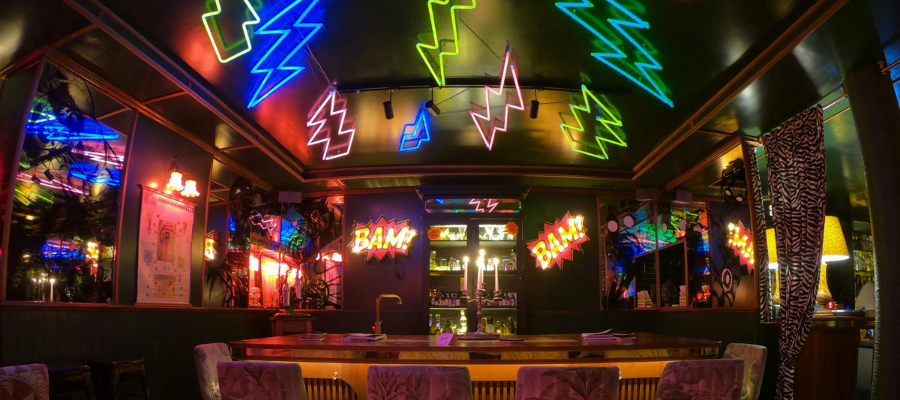 true intimacy; photo of an empty bar lit with colorful neon signs represents the bar where Susie learned a valuable lesson about true intimacy and connection